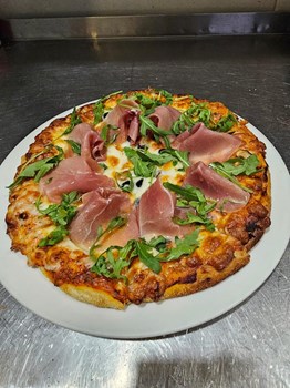 Pizza caseira com presunto serrano, azeitonas pretas e rúcula - Imagem 1